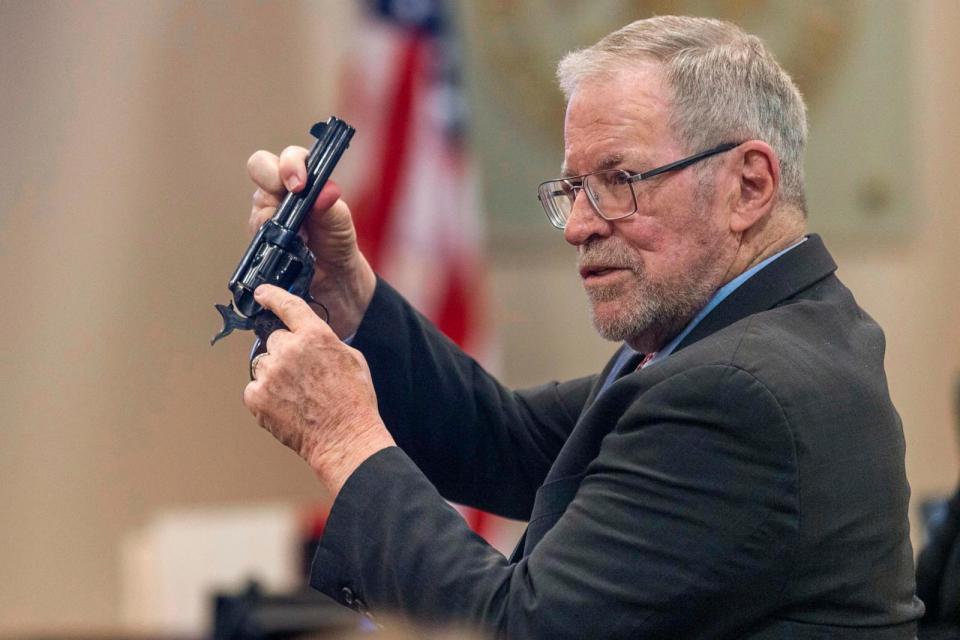 PHOTO: Lucien Haag, a witness on forensic science firearms evidence examination and shooting reconstruction, shows the jury a gun like the one used in rehearsal for the film 'Rust' at District Court in Santa Fe, N.M., Feb. 27, 2024.  (Luis Sanchez Saturno/AP)