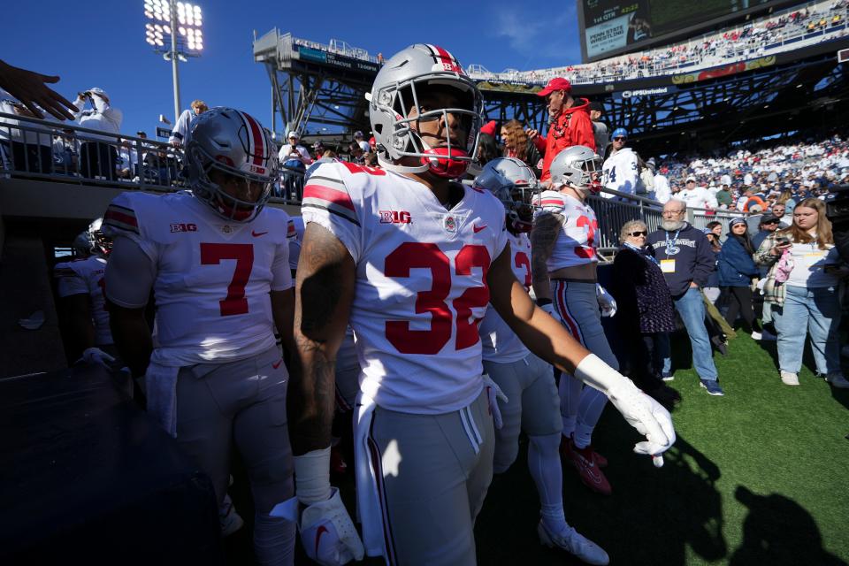 Oct 29, 2022; University Park, Pennsylvania, USA; Running back TreVeyon Henderson (32) and the Ohio State Buckeyes take the field for warm ups prior to the NCAA Division I football game against the Penn State Nittany Lions at Beaver Stadium. Mandatory Credit: Adam Cairns-The Columbus Dispatch