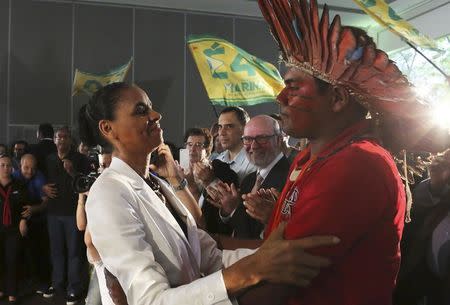 Presidential candidate Marina Silva (L) of Brazilian Socialist Party (PSB) speaks with a member of the Tupy tribe during her campaign rally in Sao Paulo September 30, 2014. REUTERS/Nacho Doce