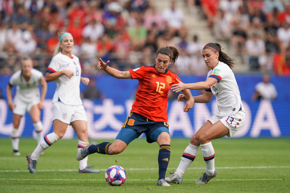 REIMS, FRANCE - JUNE 24: Patricia Guijarro #12 of Spain is marked by Alex Morgan #13 of the United States during a 2019 FIFA Women&#39;s World Cup France Round of 16 match between Spain and the United States at Stade Auguste-Delaune on June 24, 2019 in Reims, France.  (Photo by John Todd/isiphotos.com/Getty Images).