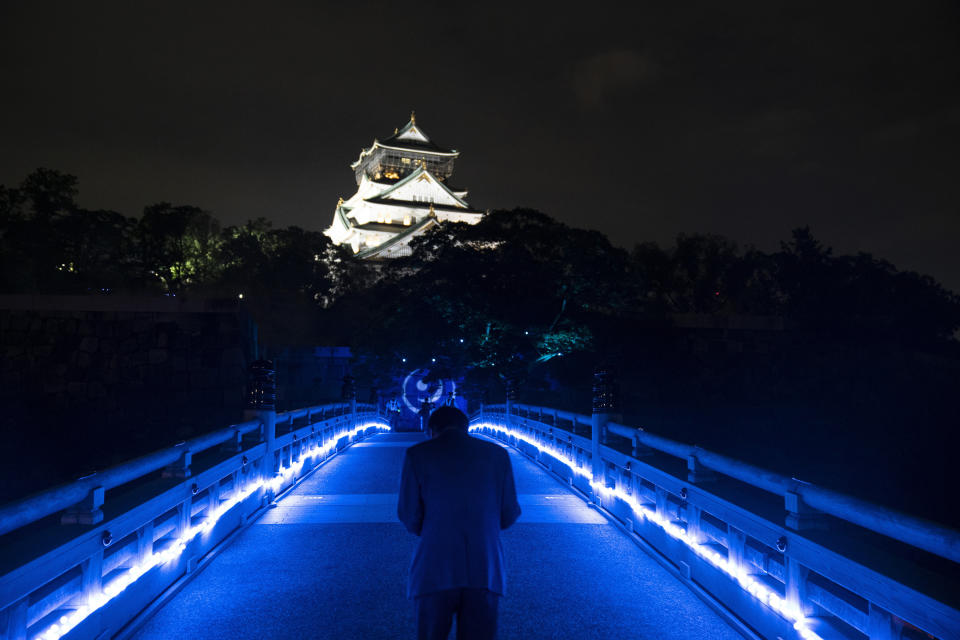 A visitor walks along a bridge towards Osaka Castle Wednesday, June 26, 2019, in Osaka, western Japan, two days before the city is hosts a two-day G-20 summit. (AP Photo/Jae C. Hong)