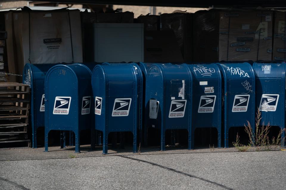 Mail boxes sit in the parking lot of a post office in the Borough of the Bronx on August 17, 2020 in New York. - The United States Postal Service is popularly known for delivering mail despite snow, rain or heat, but it faces a new foe in President Donald Trump. Ahead of the November 3 elections in which millions of voters are expected to cast ballots by mail due to the coronavirus, Trump has leveled an unprecedented attack at the USPS, opposing efforts to give the cash-strapped agency more money as part of a big new virus-related stimulus package, even as changes there have caused delays in mail delivery. (Photo by Bryan R. Smith / AFP) (Photo by BRYAN R. SMITH/AFP via Getty Images)