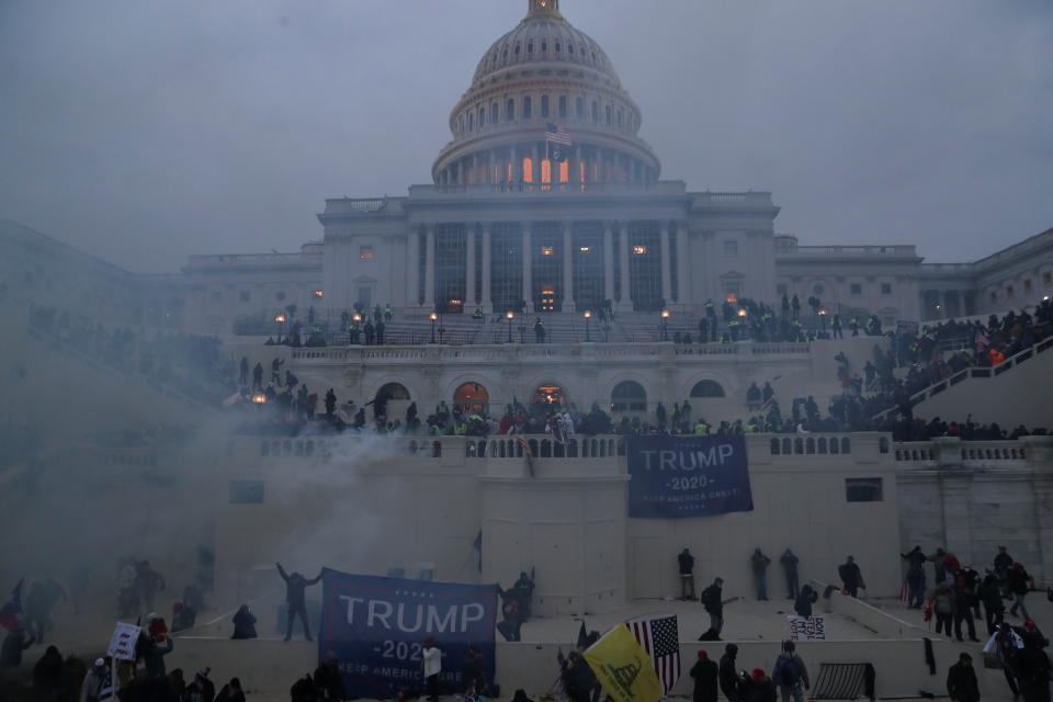 Police officers stand guard as Trump supporters gather in front of the Capitol after rioters stormed the building. (Photo: Leah Millis / Reuters)
