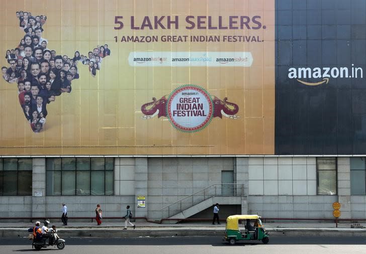 FILE PHOTO: People move past a hoarding of Amazon India outside a metro rail station in New Delhi,