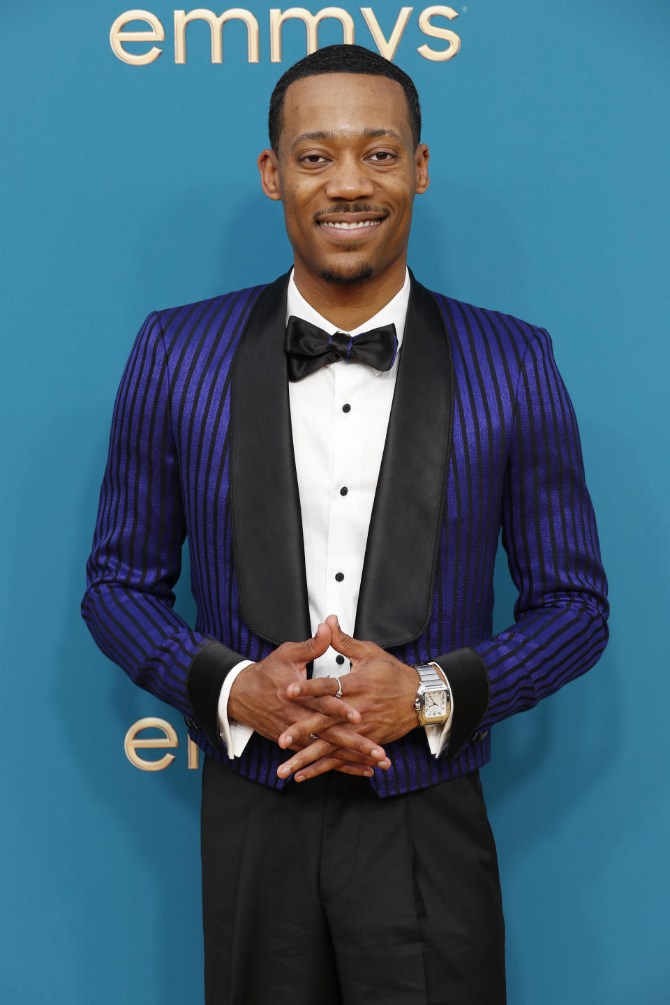 Tyler James Williams in a blue and black striped tux