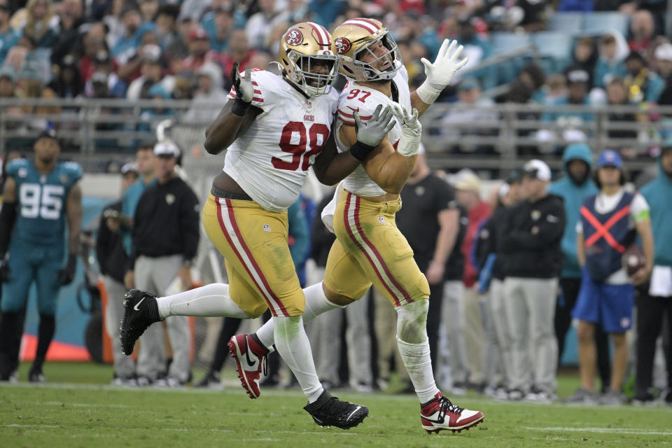 San Francisco 49ers defensive tackle Javon Hargrave (98) and defensive end Nick Bosa (97) celebrate after Bosa sacked Jacksonville Jaguars quarterback Trevor Lawrence during the second half of an NFL football game, Sunday, Nov. 12, 2023, in Jacksonville, Fla. (AP Photo/Phelan M. Ebenhack)