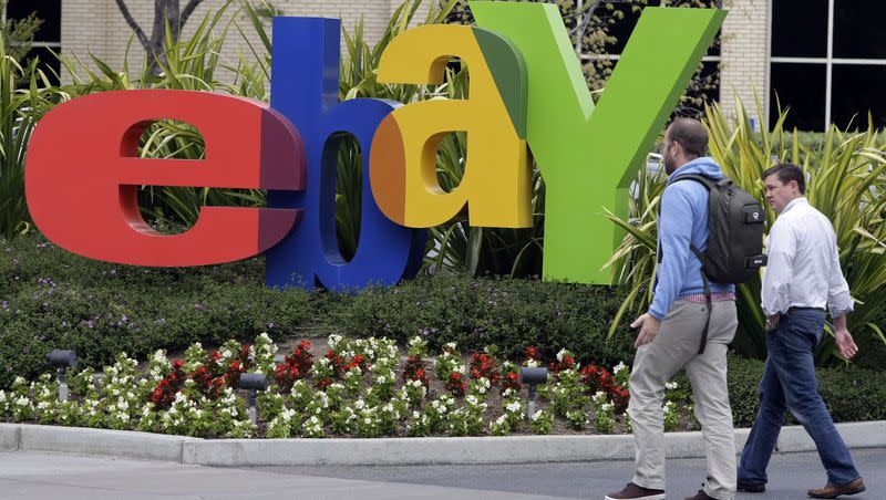 Two pedestrians pass eBay headquarters in San Jose, Calif., in this April 22, 2011, file photo.