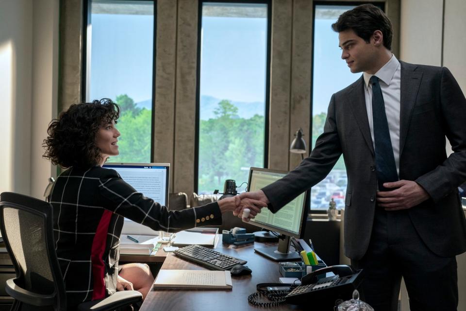 owen and amelia shaking hands at her desk