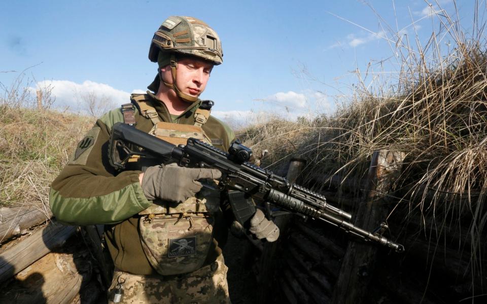 A Ukrainian soldier is seen at fighting positions on the line of separation from pro-Russian rebels near Luhansk - AP