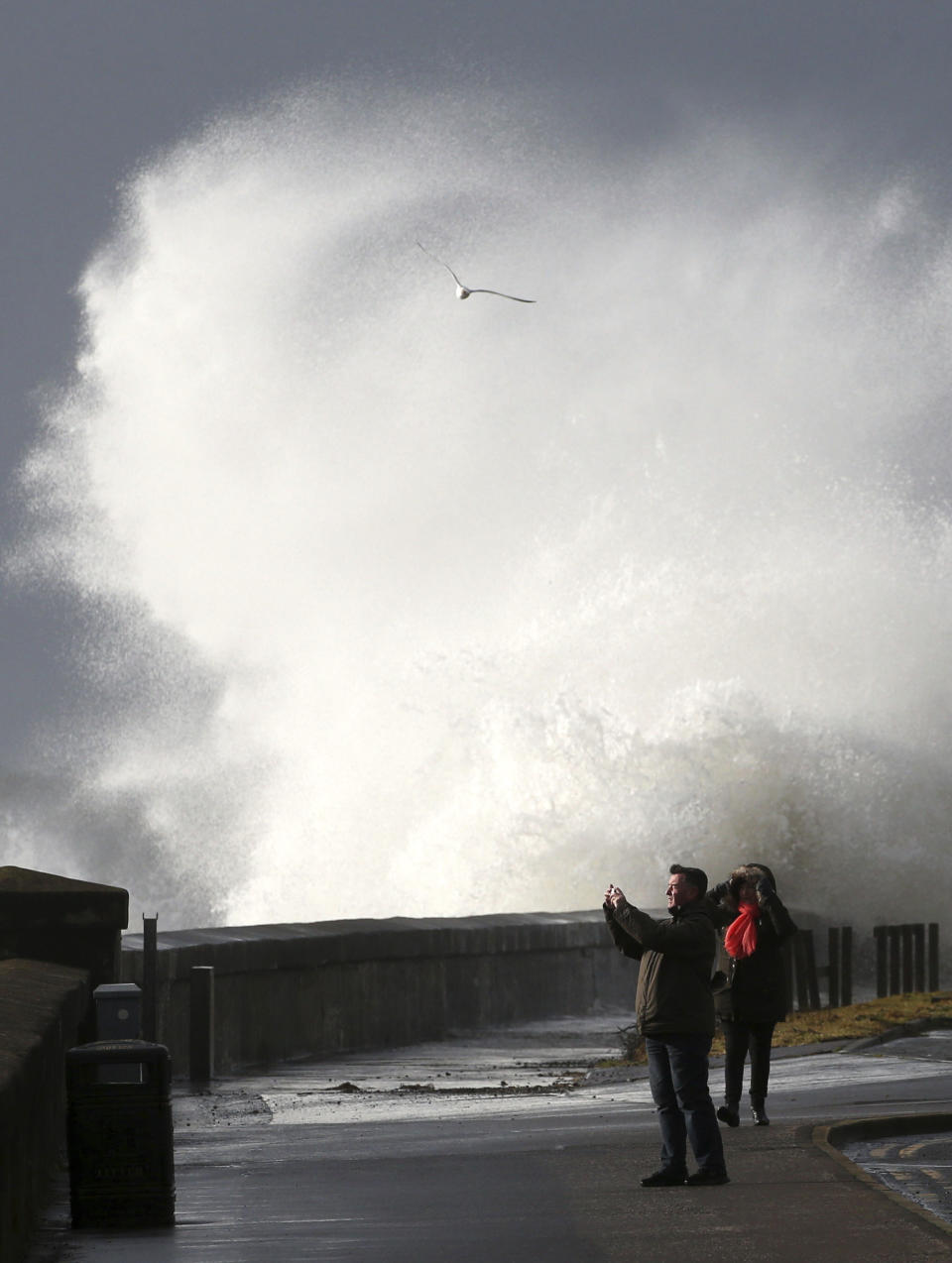 Waves batter the coastline at Saltcoats, North Ayrshire, Scotland, Sunday, Feb. 9, 2020. Trains, flights and ferries have been cancelled and weather warnings issued across the United Kingdom as a storm with hurricane-force winds up to 80 mph (129 kph) batters the region. (Andrew Milligan/PA via AP)