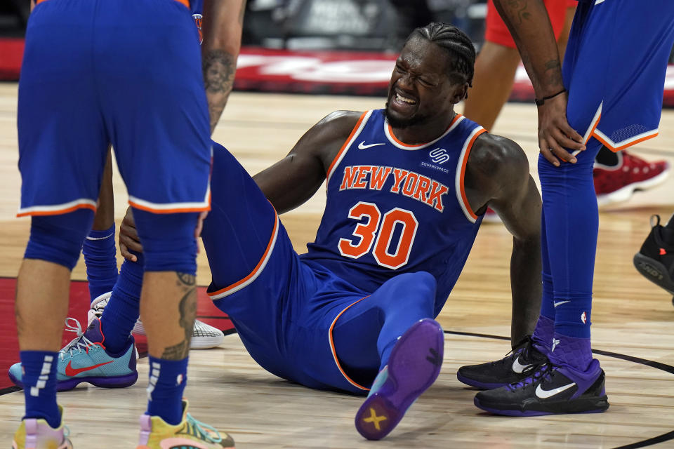 New York Knicks forward Julius Randle (30) grimaces in pain after getting fouled by Toronto Raptors forward Chris Boucher during the second half of an NBA basketball game Thursday, Dec. 31, 2020, in Tampa, Fla. (AP Photo/Chris O'Meara)