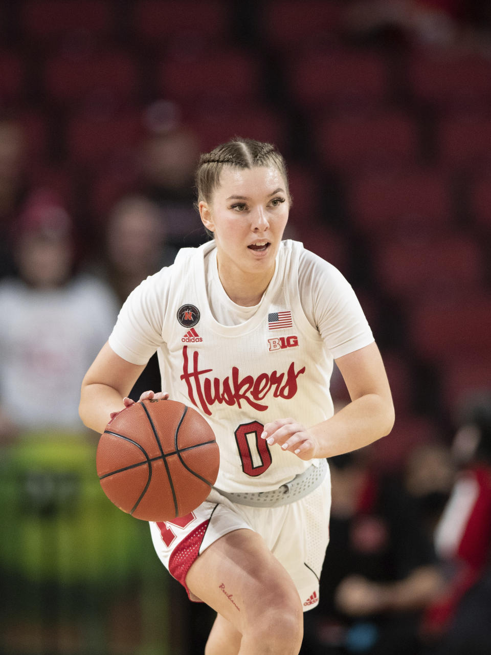 FILE - Nebraska's Ashley Scoggin (0) plays against Michigan during the second half of an NCAA college basketball game Tuesday, Jan. 4, 2022, in Lincoln, Neb. The former Nebraska women's basketball player alleges coach Amy Williams and athletic director Trev Alberts did not take appropriate action when her sexual relationship with an assistant coach became widely known. Scoggin filed a civil lawsuit on Sunday, Feb. 18, 2024, in U.S. District Court describing how Chuck Love allegedly took a special interest in her and how the relationship turned sexual and caused Scoggin to fear retaliation if she refused to engage in it. (AP Photo/Rebecca S. Gratz, File)