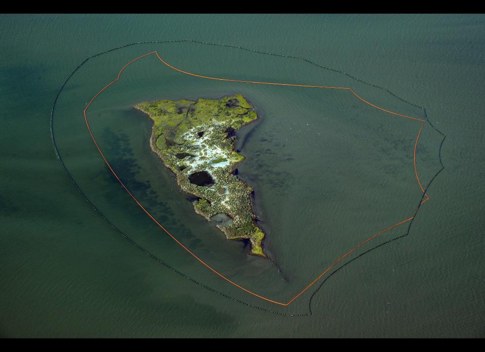 One of the New harbor Islands is protected by two oil booms against the oil slick that has passsed inside of the protective barrier formed by the Chandeleur Islands, as cleanup operations continue for the BP Deepwater Horizon platform disaster off Louisiana, on May 10, 2010.  Days after failing to contain the Gulf of Mexico oil spill with a giant dome, BP said it will make a second attempt this week using a smaller version dubbed the "top hat." A four-story, 100-ton box was lowered Friday to the seabed to try to capture most of the oil and allow it to be funneled up to a ship on the surface, but it was rendered useless on Sunday when ice crystals formed in its domed roof. BP experts believe the smaller "top hat" containment box would not suffer the same problem as it would not hold so much freezing cold seawater, and they are preparing to drop it into the inky depths to carry out a similar fix to what is unfolding as one the worst oil spills in US history. (Mark Ralston, AFP / Getty Images)