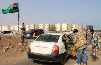 Supporters of the southern separatist movement and the Saudi led-coalition conducting air raids on rebel positions check a vehicle at a checkpoint in Aden on April 7, 2015