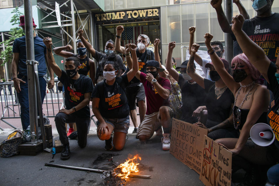 Protesters shout slogans against U.S. President Donald Trump during a protest outside Trump Tower on Fifth Avenue, Saturday, July 4, 2020, in New York. (AP Photo/Eduardo Munoz Alvarez)