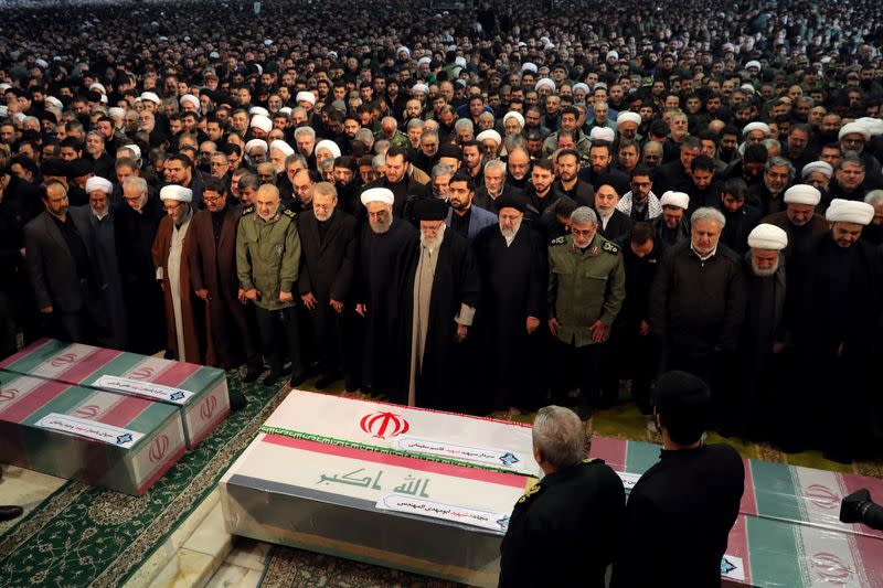 Iran's Supreme Leader Khamenei and President Rouhani pray near the coffins of Iranian Major-General Qassem Soleimani and Iraqi militia commander Abu Mahdi al-Muhandis in Tehran