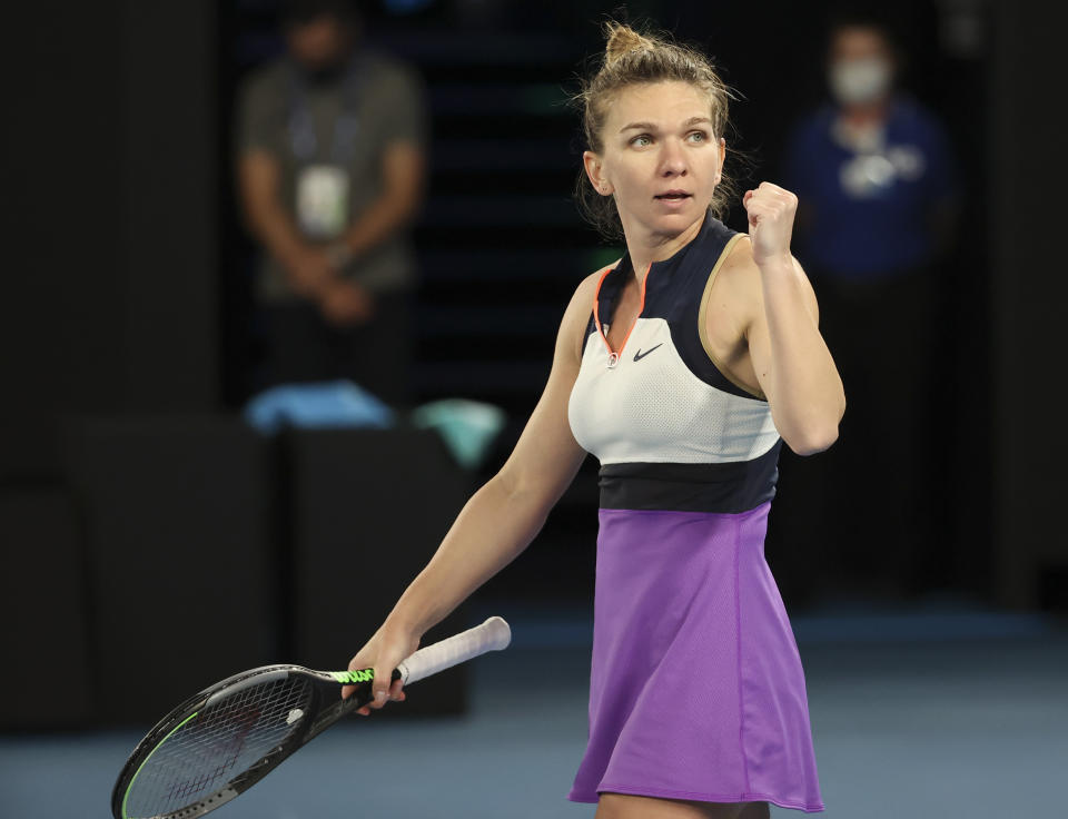 Romania's Simona Halep celebrates after defeating Poland's Iga Swiatek in their fourth round match at the Australian Open tennis championship in Melbourne, Australia, Sunday, Feb. 14, 2021.(AP Photo/Hamish Blair)