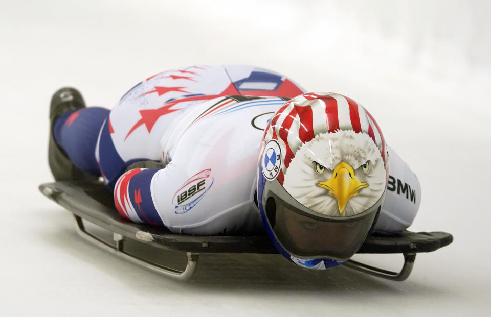 Katie Uhlaender of United States speeds down the track during the woman Skeleton World Cup race in Sigulda, Latvia, Friday, Dec. 31, 2021. (AP Photo/Roman Koksarov)