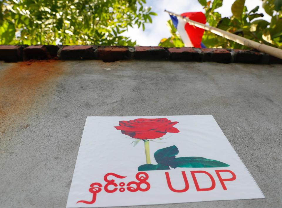 A poster of the United Democratic Party is posted on the wall of the party's headquarters Wednesday, Sept. 30, 2020, in Naypyitaw, Myanmar. Kyaw Myint, the chairman of the United Democratic Party has been arrested as a fugitive from justice after recent reports in Myanmar media contained allegations of a shady past, including financial finagling and a prison escape. The party is fielding the second highest number of candidates for the November elections, and other party executives say it will carry on campaigning. (AP Photo / Aung Shine Oo)