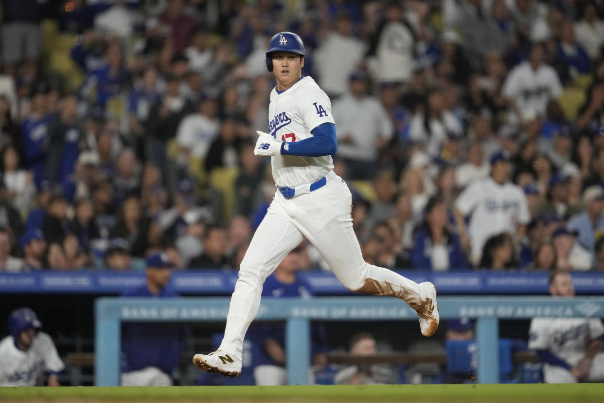 Los Angeles Dodgers designated hitter Shohei Ohtani (17) scores off of a single by Teoscar Hernández during the seventh inning of a baseball game against the Colorado Rockies in Los Angeles, Friday, Sept. 20, 2024. (AP Photo/Ashley Landis)