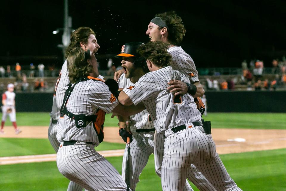 Marcus Brown (19) scores the game winning run as the Oklahoma Sooners take on the Oklahoma State Cowboys at O'Brate Stadium on OSU campus in Stillwater on Saturday, April 9, 2022.