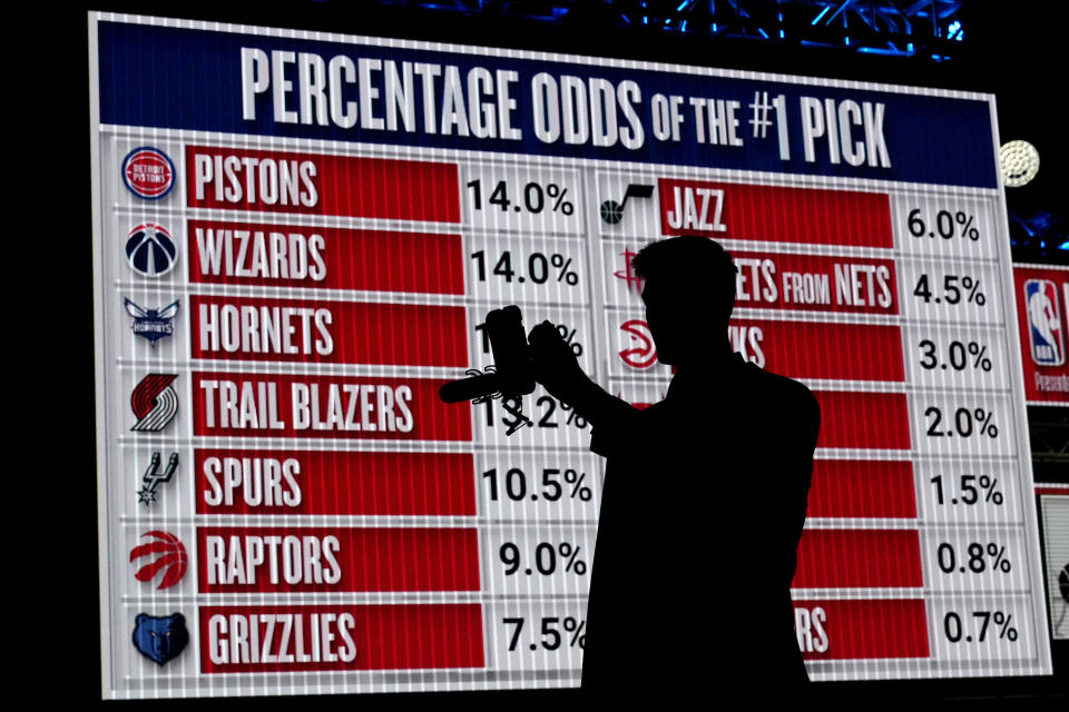 NBA basketball draft prospect Kyle Filipowski takes video by himself in front of the draft lottery order before the draft lottery in Chicago, Sunday, May 12, 2024. (AP Photo/Nam Y. Huh)