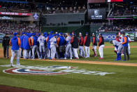 Washington Nationals and New York Mets scuffle after New York Mets' Francisco Lindor, bending over at right, was hit by a pitch from Washington Nationals relief pitcher Steve Cishek during the fifth inning of a baseball game at Nationals Park, Friday, April 8, 2022, in Washington. (AP Photo/Alex Brandon)