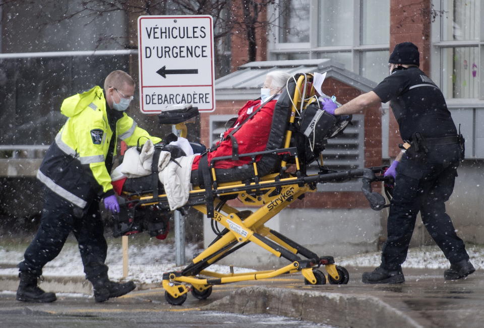 Paramedics transfer a person from a seniors retirement home to a hospital in Montreal, Monday, Dec. 28, 2020, as the COVID-19 pandemic continues in Canada and around the world. (Graham Hughes/The Canadian Press via AP)