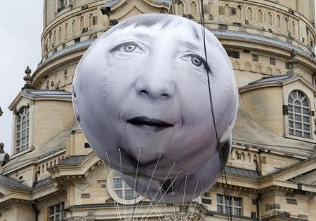 A balloon made by the 'ONE' campaigning organisation depicting German Chancellor Angela Merkel, one of the leaders of the countries members of the G7, is pictured in front of the Frauenkirche cathedral in Dresden, Germany, May 27, 2015. REUTERS/Fabrizio Bensch