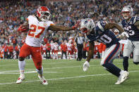<p>Kareem Hunt #27 of the Kansas City Chiefs stiff arms Duron Harmon #30 of the New England Patriots as he runs for a 4-yard rushing touchdown during the fourth quarter against the New England Patriots at Gillette Stadium on September 7, 2017 in Foxboro, Massachusetts. (Photo by Maddie Meyer/Getty Images) </p>