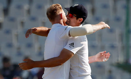 Cricket - India v England - Third Test cricket match - Punjab Cricket Association Stadium, Mohali, India - 28/11/16. England's Ben Stokes (L) and Alastair Cook celebrate the dismissal of India's Ravichandran Ashwin. REUTERS/Adnan Abidi