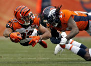 <p>Cincinnati Bengals wide receiver Tyler Boyd (83) lunges for yards as Denver Broncos free safety Bradley Roby (29) makes the hit during the first half of an NFL football game, Sunday, Nov. 19, 2017, in Denver. (AP Photo/David Zalubowski) </p>