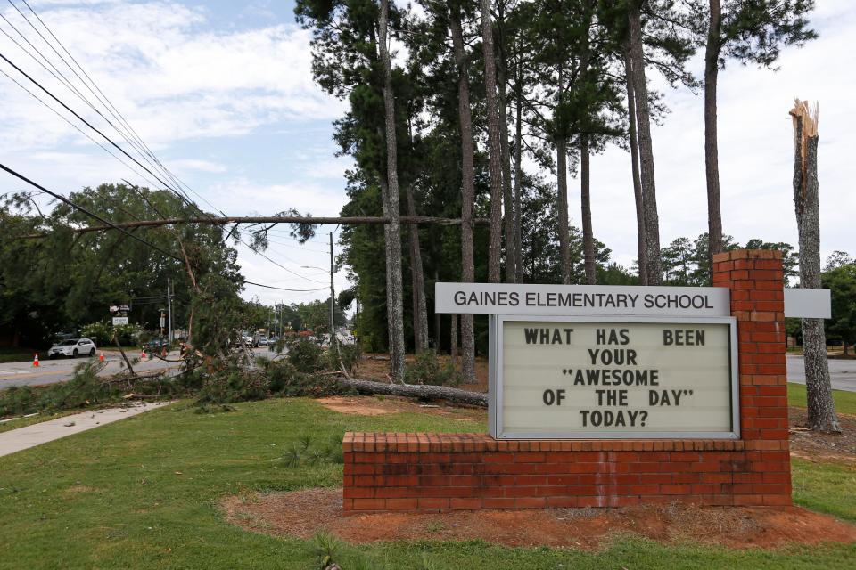 Trees fell onto power lines and in the road at Gaines Elementary School after a severe storm in Athens, Ga., on Friday, July 21, 2023.