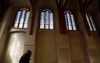 Leo Pavlat, director of the Jewish Museum, walks through the closed Pinkas Synagogue in Prague