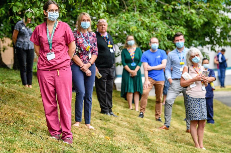 <span class="caption">Hospital and nursing staff wear face masks and observes social distancing guidelines at an event in the U.K.</span> <span class="attribution"><a class="link " href="https://www.gettyimages.com/detail/news-photo/hospital-and-nursing-staff-wear-ppe-of-face-masks-or-news-photo/1220414378" rel="nofollow noopener" target="_blank" data-ylk="slk:Ben Birchall /Getty Images;elm:context_link;itc:0;sec:content-canvas">Ben Birchall /Getty Images</a></span>