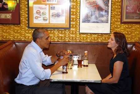 U.S. President Barack Obama visits with Rebekah Erler at Matt's Bar, after receiving a letter from her explaining what it is like living in her shoes, in Minneapolis, Minnesota June 26, 2014. REUTERS/Larry Downing