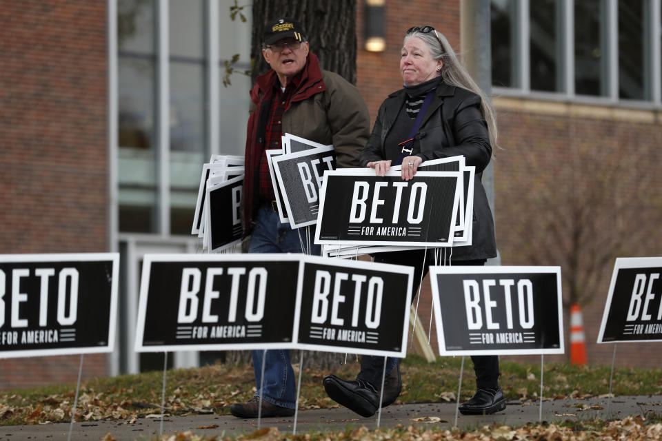 Supporters for Democratic presidential candidate Beto O'Rourke carry signs while waiting for him to speak before the Iowa Democratic Party's Liberty and Justice Celebration, Friday, Nov. 1, 2019, in Des Moines, Iowa. O'Rourke told his supporters that he was ending his presidential campaign. (AP Photo/Charlie Neibergall)