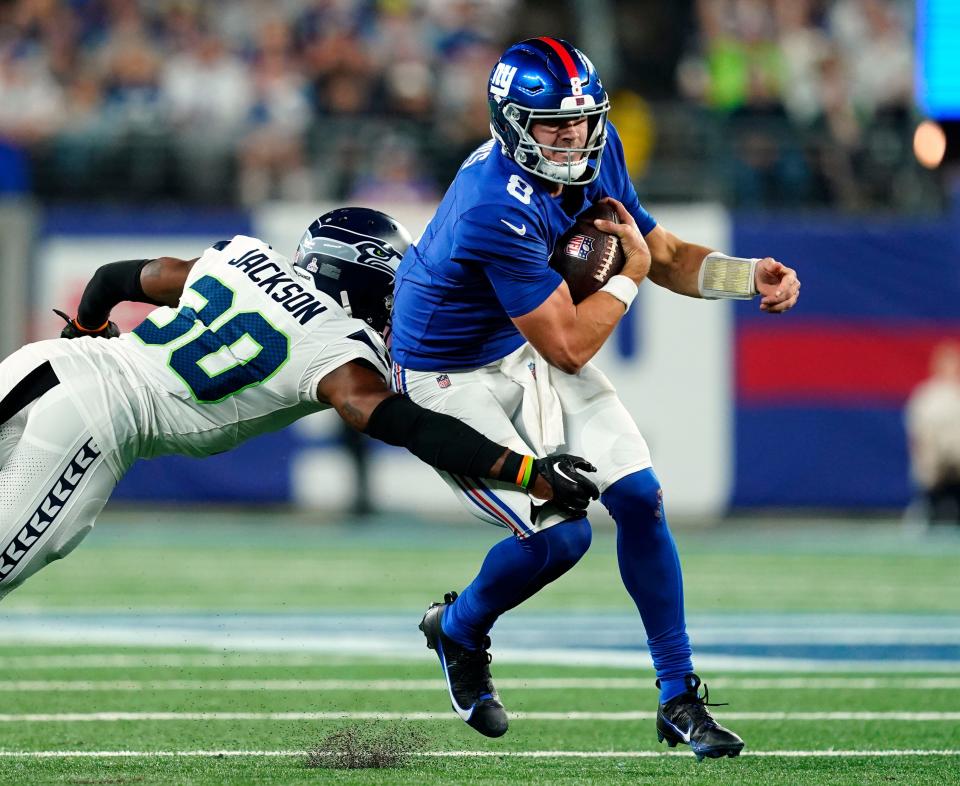 Seattle Seahawks cornerback Michael Jackson (30) tackles New York Giants quarterback Daniel Jones (8) in the second half. The Seahawks defeat the Giants, 24-3, at MetLife Stadium on Monday, Oct. 2, 2023, in East Rutherford.