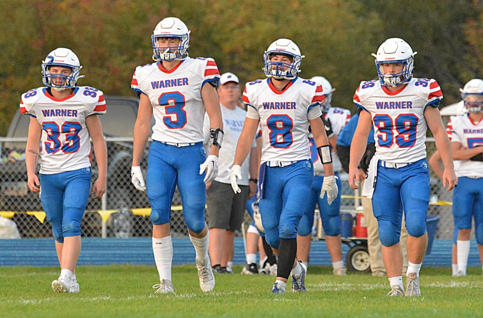 Warner captains Charlie Dulany (33), Brodey Sauerwein (3), Hunter Cramer (8) and Alex Pudwill (39) head to midfield for the pre-game coin toss prior to a high school football game against Hamlin on Friday, Sept. 29, 2023 in Hayti. No. 1 Class 9A Warner beat No. 2 Class 9AA Hamlin 22-13.