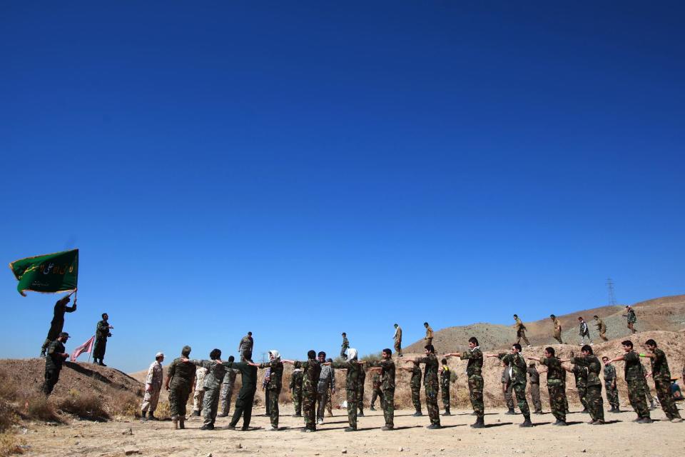 In this Thursday, Sept. 19, 2013 photo, members of the Basij paramilitary militia attend a training session, in Tehran, Iran. Authorities created the Basij, which means mobilization in Persian, just after the country’s 1979 Islamic Republic. It is part of Iran’s powerful Revolutionary Guard. (AP Photo/Ebrahim Noroozi)