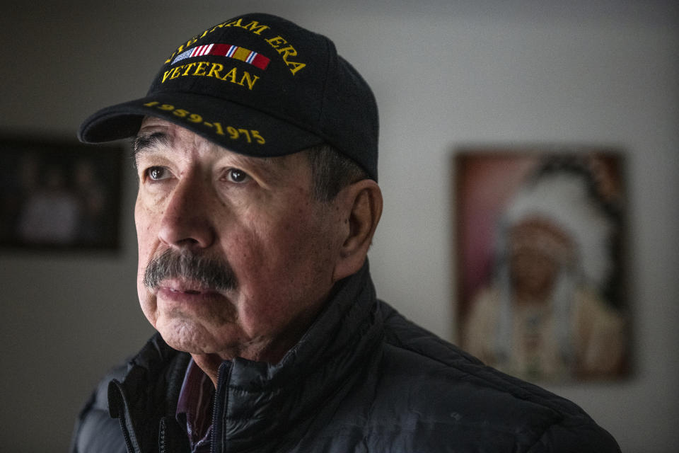 Richard King, 70, looks out of the window in his home at the King family ranch near Zortman, Mont., on the Fort Belknap Indian Reservation on Sunday, Dec. 8, 2019. King is the oldest of 11 siblings, three of which live on the ranch. (AP Photo/Tommy Martino)