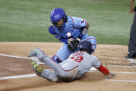 Texas Rangers catcher Jonah Heim, top, bobbles the ball as Washington Nationals' Juan Soto, bottom, scores during the first inning of a baseball game Sunday, June 26, 2022, in Arlington, Texas. (AP Photo/Michael Ainsworth)