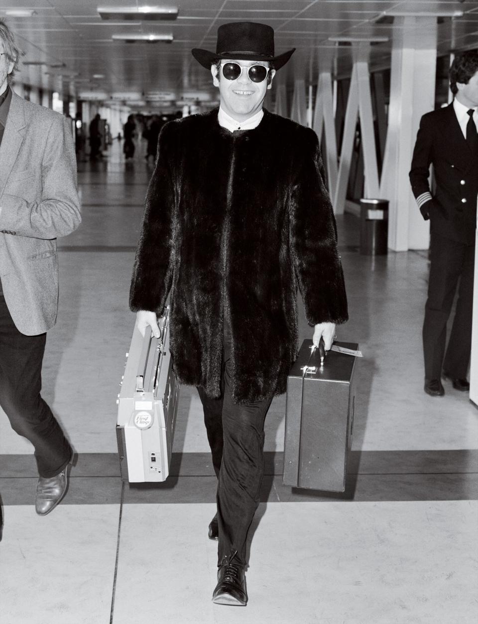 <p>The Rocket Man accessorized with a boom box en route to the Concorde (his preferred method of crossing the Atlantic until the planes were retired in 2003) for a flight from London's Heathrow to N.Y.C.</p>