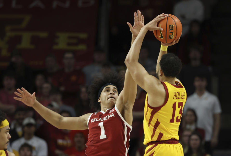 Oklahoma forward Jalen Hill (1) contests the shot by Iowa State guard Jaren Holmes (13) during the second half of an NCAA college basketball game, Saturday, Feb. 25, 2023, in Ames, Iowa. (AP Photo/Justin Hayworth)