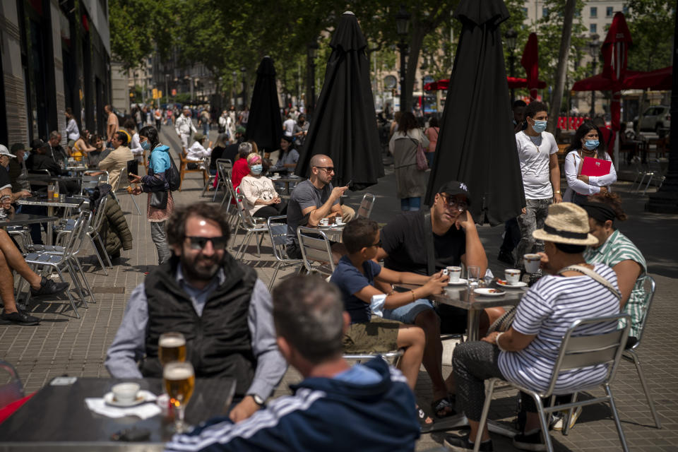 Customers sit in a terrace bar in downtown Barcelona, Spain, Friday, May 28, 2021. (AP Photo/Emilio Morenatti)