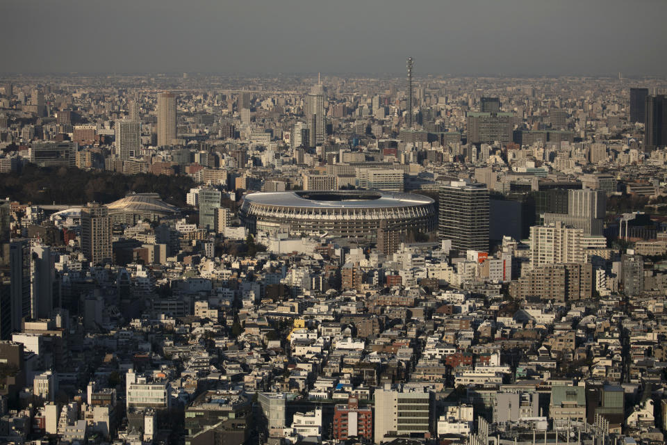 FILE - In this Monday, Jan. 20, 2020, file photo, New National Stadium, center, a venue for the opening and closing ceremonies at the Tokyo 2020 Olympics, is seen from Shibuya Sky observation deck in Tokyo. The Tokyo Olympics open exactly six months from Friday, Jan. 24, 2020 and the United States and China are picked to finish 1-2 in the overall medal count and the gold-medal count. That's the easy part in a forecast done by Gracenote Sports about which countries will win the most Olympic medals. Gracenote supplies analysis for leagues around the world and has a solid track record forecasting recent Olympics. (AP Photo/Jae C. Hong, File)