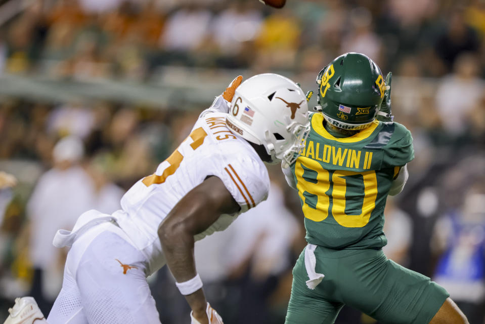 Baylor wide receiver Monaray Baldwin (80) catches a pass next to Texas defensive back Ryan Watts (6) during the second half of an NCAA college football game Saturday, Sept. 23, 2023, in Waco, Texas. (AP Photo/Gareth Patterson)