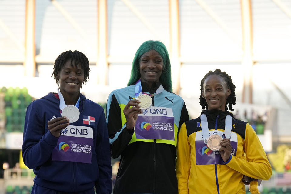 Gold medalist Shaunae Miller-Uibo, of Bahamas, center, stands with silver medalist Marileidy Paulino, of the Dominican Republic, left, and bronze medalist Sada Williams, of Barbados, during a medal ceremony for wins the final of the women's 400-meter run at the World Athletics Championships on Friday, July 22, 2022, in Eugene, Ore. (AP Photo/Gregory Bull)