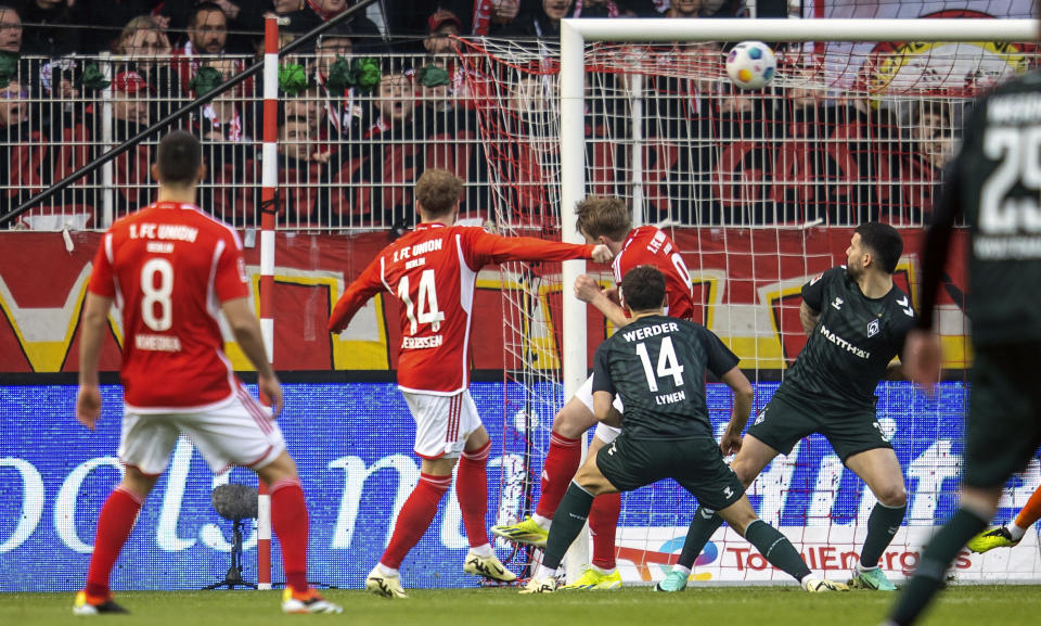 Berlin's Yorbe Vertessen, second from left, scores their side's first goal of the game during the Bundesliga soccer match between 1. FC Union Berlin and Werder Bremen in Berlin, Germany, Saturday March 16, 2024. (Andreas Gora/dpa via AP)