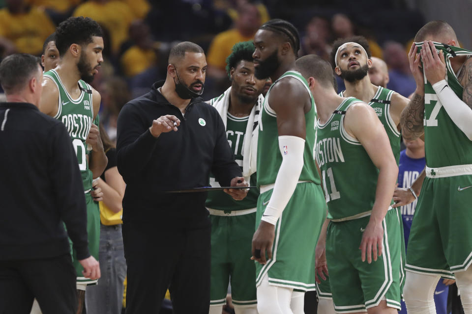 FILE - Boston Celtics head coach Ime Udoka, center left, talks with players during the first half of Game 2 of basketball's NBA Finals against the Golden State Warriors in San Francisco, Sunday, June 5, 2022. The Boston Celtics are planning to discipline coach Ime Udoka, likely with a suspension, because of an improper relationship with a member of the organization, two people with knowledge of the matter told The Associated Press on Thursday, Sept. 22, 2022. (AP Photo/Jed Jacobsohn, File)